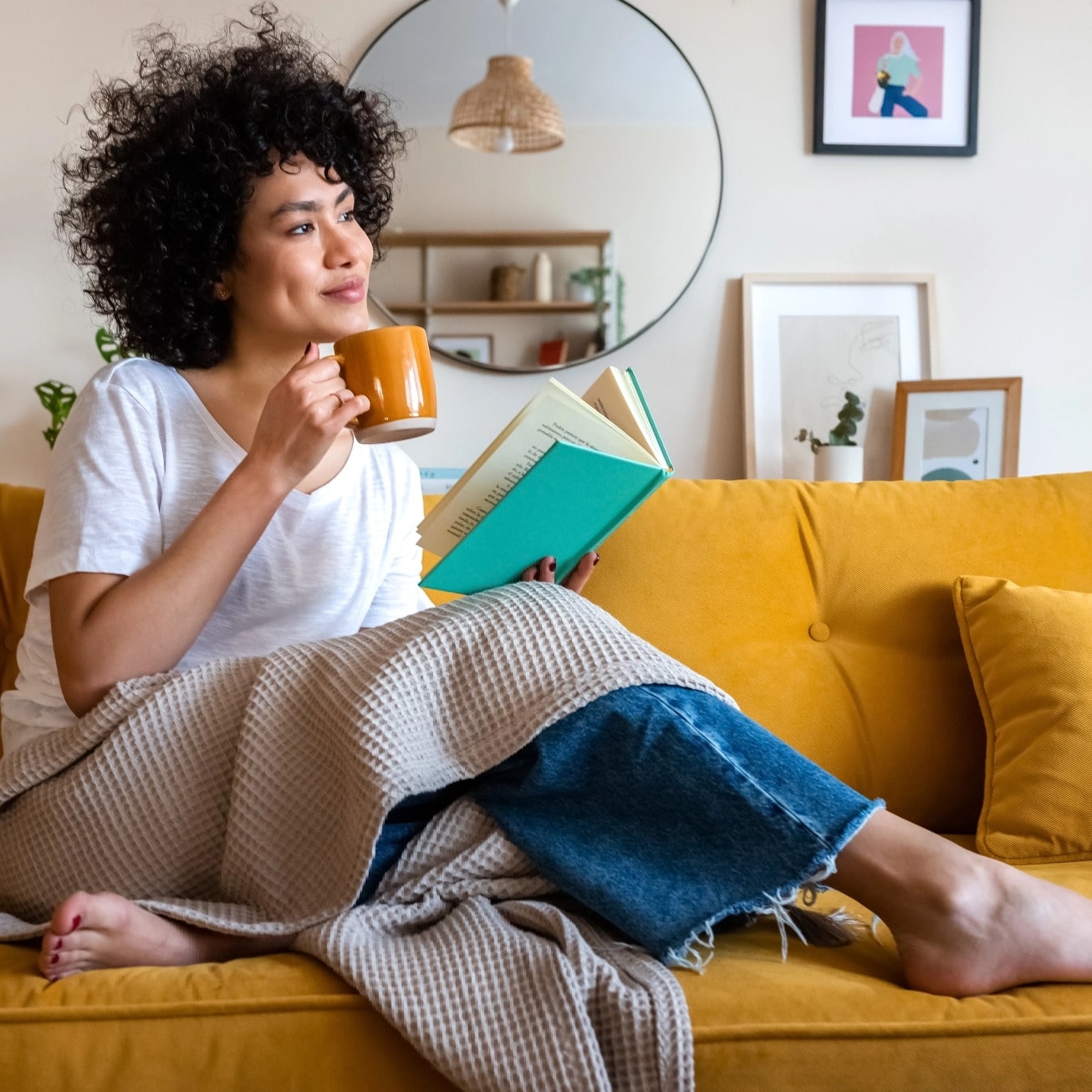woman drinking coffee on a couch